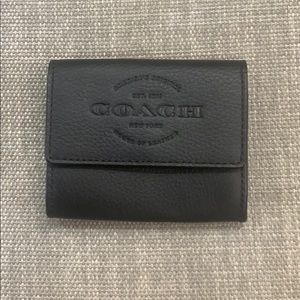 NWT Coach black leather wallet.